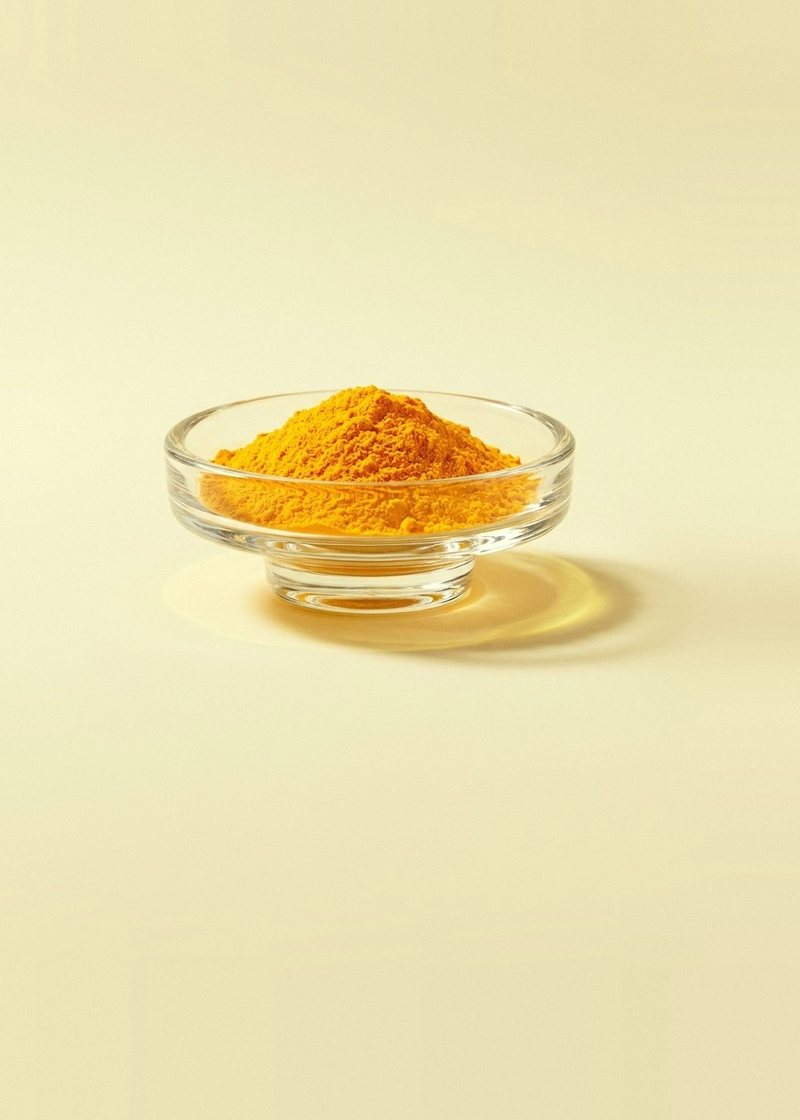 Bright orange-yellow vitamin B2 (riboflavin-5-phosphate) powder in a glass dish