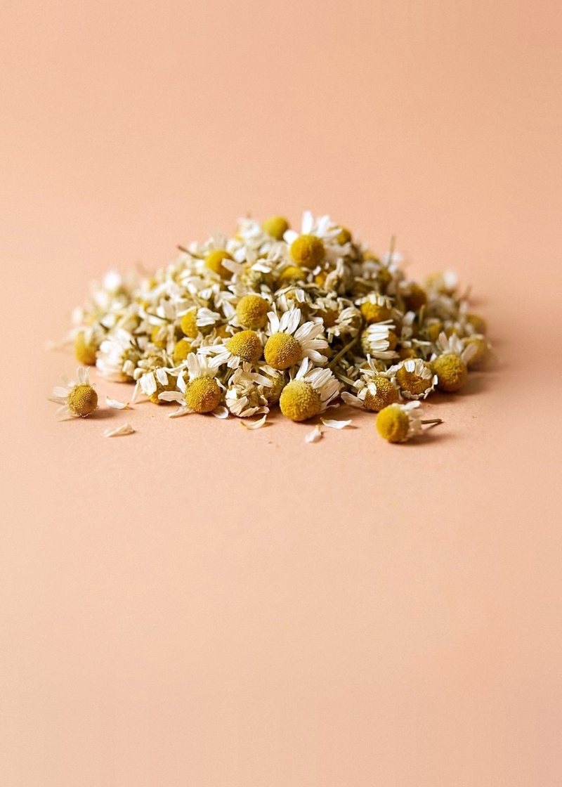 A mound of dried chamomile flowers