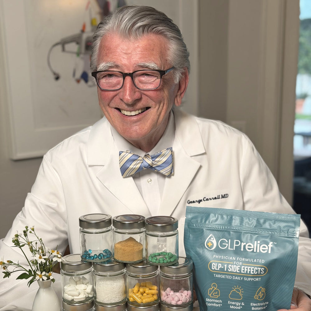 Dr. George W. Carroll, MD, in his white coat and bow tie, holding a GLPrelief bag beside glass jars of ingredients